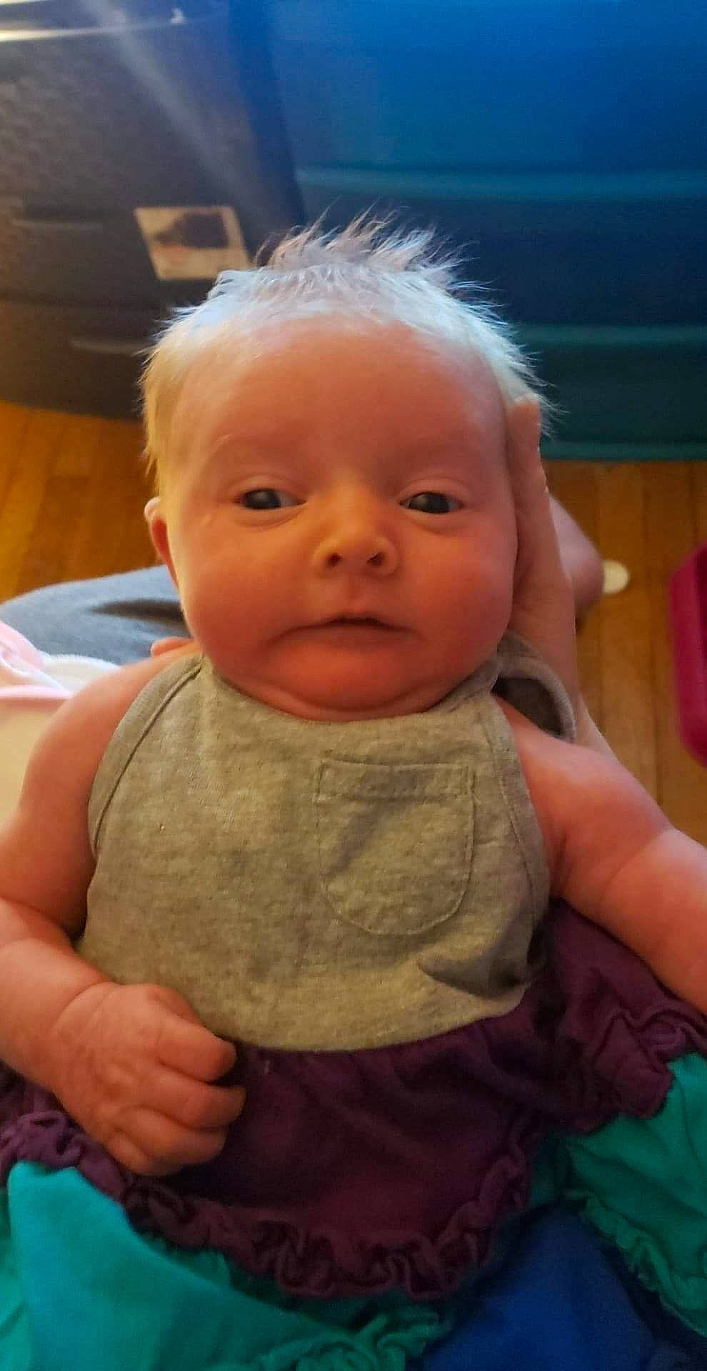 Emmalee is registered to the contest to win money with this photo: baby, baby_toddler_clothing, blue, cheek, chin, ear, eyebrow, finger, forehead, gesture, hand, head, iris, lip, mouth, nose, person, skin, sleeve, smile