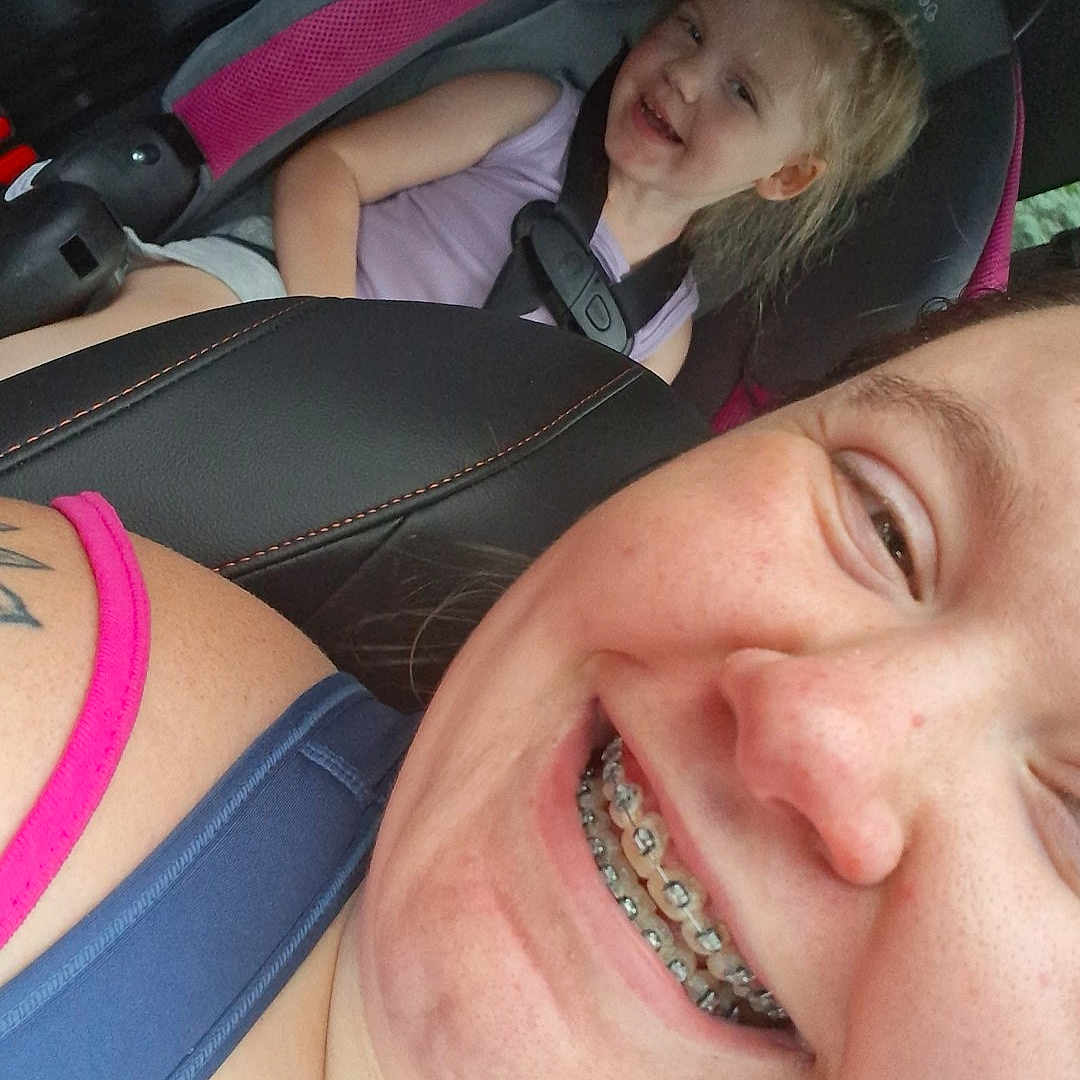 Oakley joined the competition — help win amazing prizes! braces, car, car_seat, casual, child, clothing, daylight, face, hair, happy, interior, people, portrait, relaxed, safety, seat, seatbelt, smile, transportation, woman