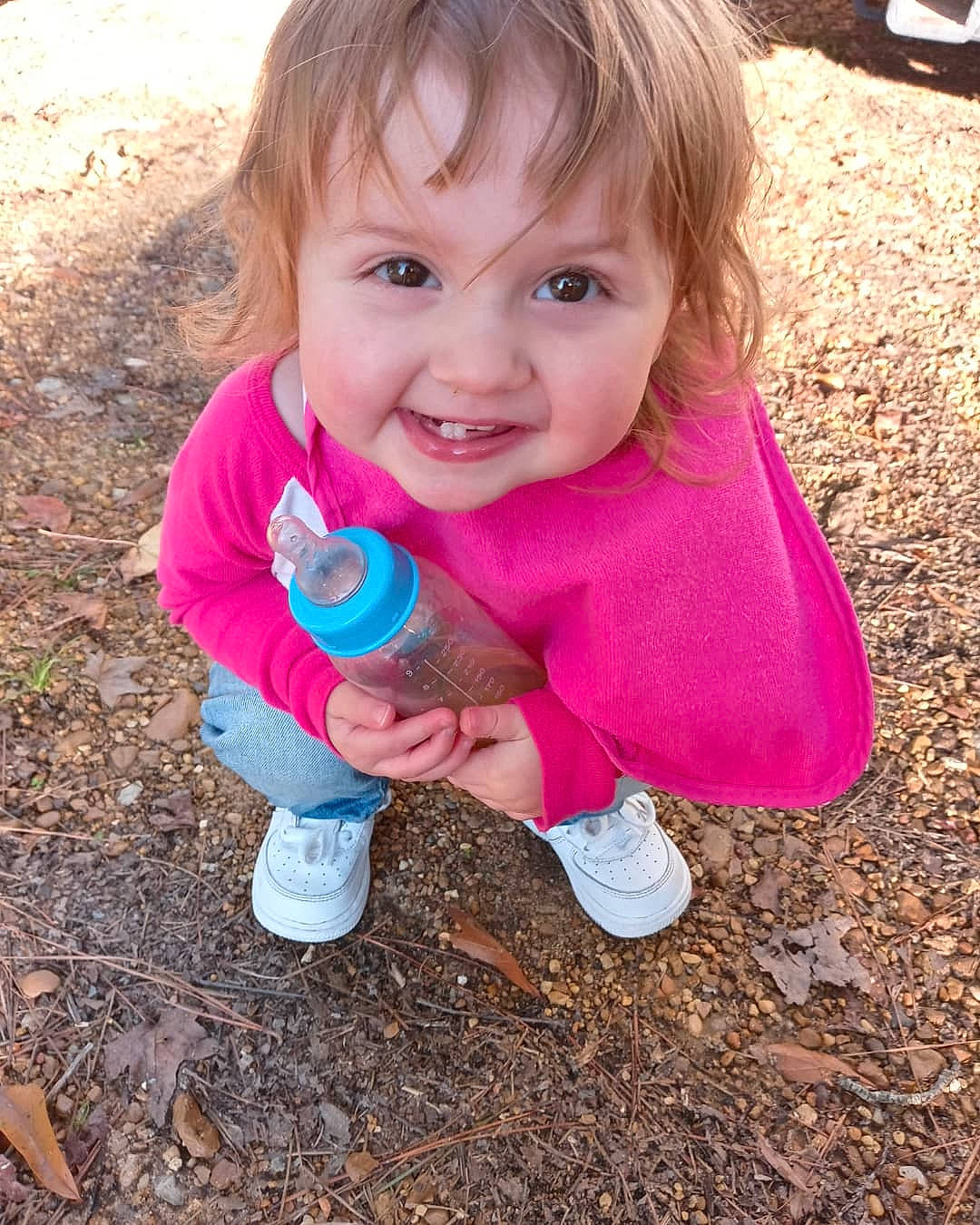 Caylee is registered to the contest to win money with this photo: baby_toddler_clothing, cheek, child, face, finger, fun, grass, hand, happy, head, leaf, leisure, people_in_nature, person, pink, recreation, smile, sneakers, thumb, toddler