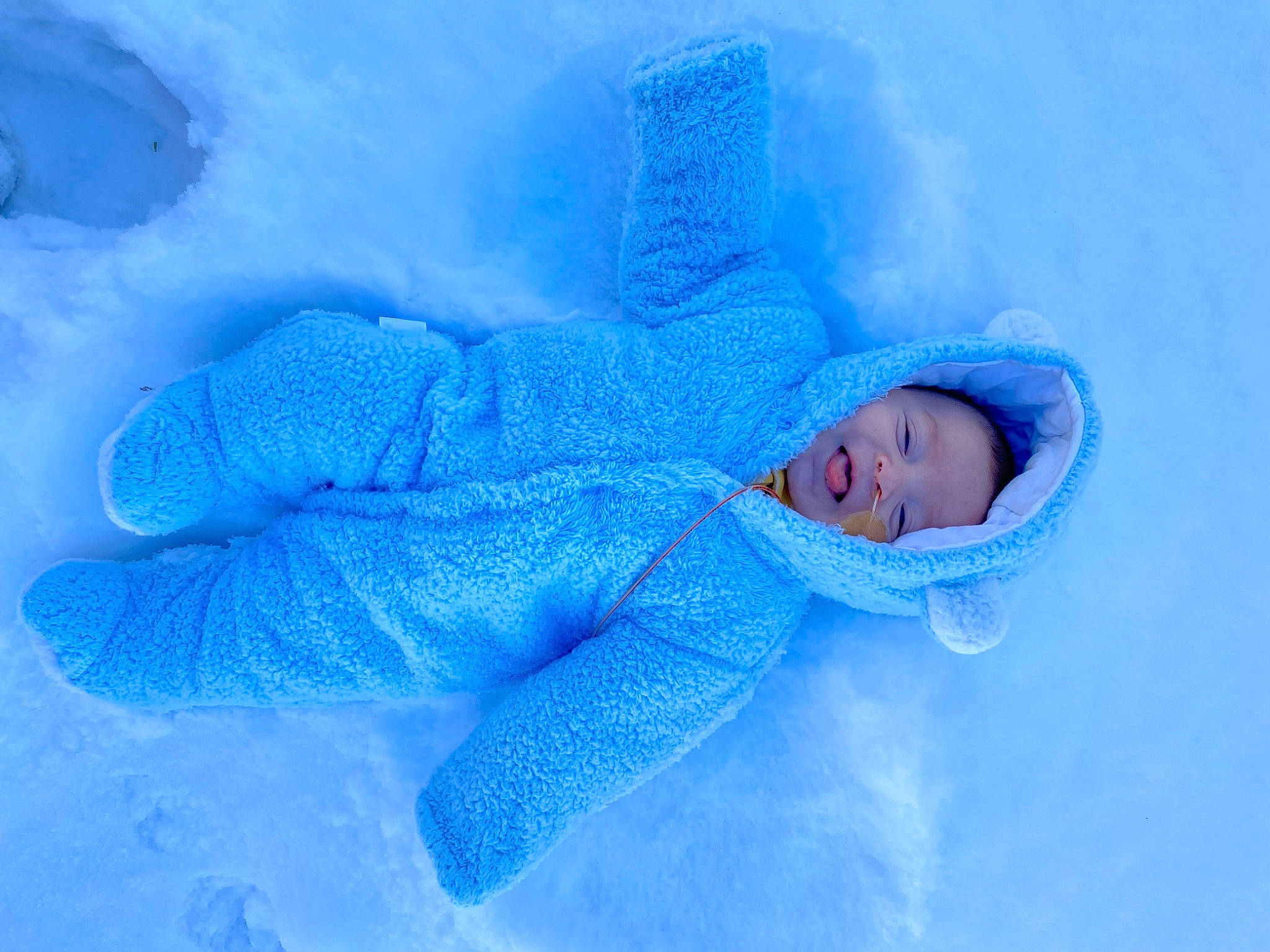 Mateo is registered to the contest to win money with this photo: azure, baby, baby_sleeping, baby_toddler_clothing, child, cloud, comfort, electric_blue, freezing, fur, linens, person, portrait_photography, room, snow, textile, toddler, winter