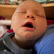Stevie is registered to the contest to win money with this photo: baby, blue, child, closeup, clothing, cozy, cute, face, head, indoors, infant, mouth_open, newborn, peaceful, person, portrait, resting, skin, sleeping, soft