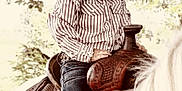 Lainey is registered to the contest to win money with this photo: child, cowboy_hat, horse, saddle, denim_jeans, striped_shirt, boots, outdoor, nature, tree, leaves, portrait, riding, western, young_child, animal, equestrian, sunlight, daytime, cute