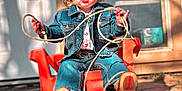 Lainey is registered to the contest to win money with this photo: child, denim_jacket, red_cap, lasso, plastic_chair, outdoor, backyard, pavement, door, window, sunlight, cowboy, jeans, footwear, playful, posing, young_child, hat, rope, expression