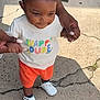 toddler, child, person, standing, outdoor, concrete, clothing, tshirt, shorts, shoes, hands, support, sunlight, shadow, casual, cute, happy, young, smiling, baby