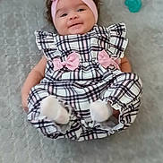 Miracle joined the competition — help win amazing prizes! baby, infant, smile, headband, pink, plaid, dress, bow, pacifier, lying, soft_surface, cute, child, happy, indoors, person, footwear, sock, texture, fabric
