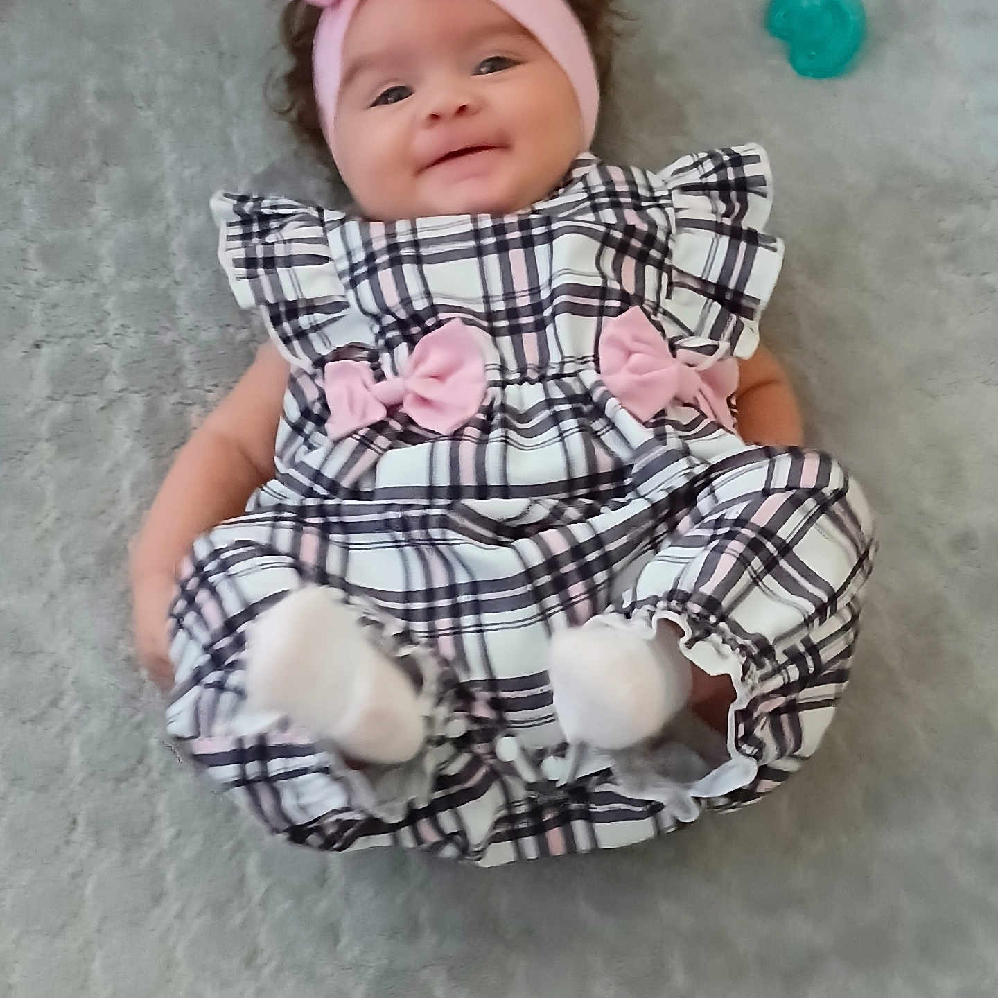 Miracle joined the competition — help win amazing prizes! baby, infant, smile, headband, pink, plaid, dress, bow, pacifier, lying, soft_surface, cute, child, happy, indoors, person, footwear, sock, texture, fabric