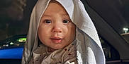 Enzo is registered to the contest to win money with this photo: baby, blanket, car, child, clothing, cute, expression, face, hood, indoors, infant, interior, light, night, person, portrait, seat, sitting, window, young
