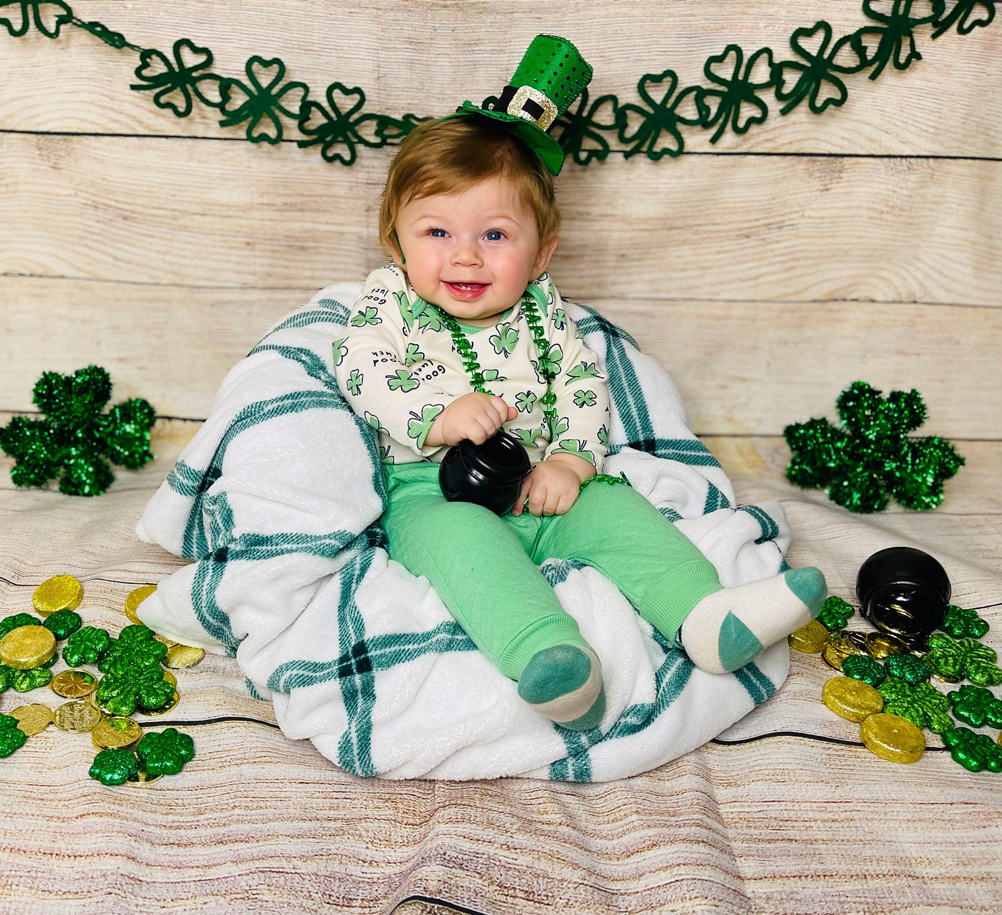 Jace is registered to the contest to win money with this photo: baby_toddler_clothing, child, christmas, christmas_decoration, christmas_eve, comfort, event, fashion_accessory, font, green, happy, holiday, joy, lap, ornament, pattern, person, sitting, sleeve, sock