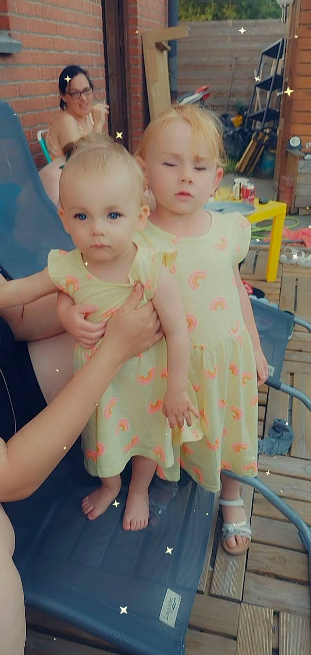 Yllona participe au concours pour gagner de l'argent avec cette photo : baby, baby_toddler_clothing, cheek, child, dress, event, eye, fashion_design, flooring, fun, gesture, hairstyle, happy, person, pink, room, shelf, sitting, skin, standing