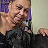 affection, animal, black_dog, close_up, comfort, cuddling, dog, expression, face, friendship, hair, indoor, love, person, pet, portrait, relaxed, skin, smiling, woman