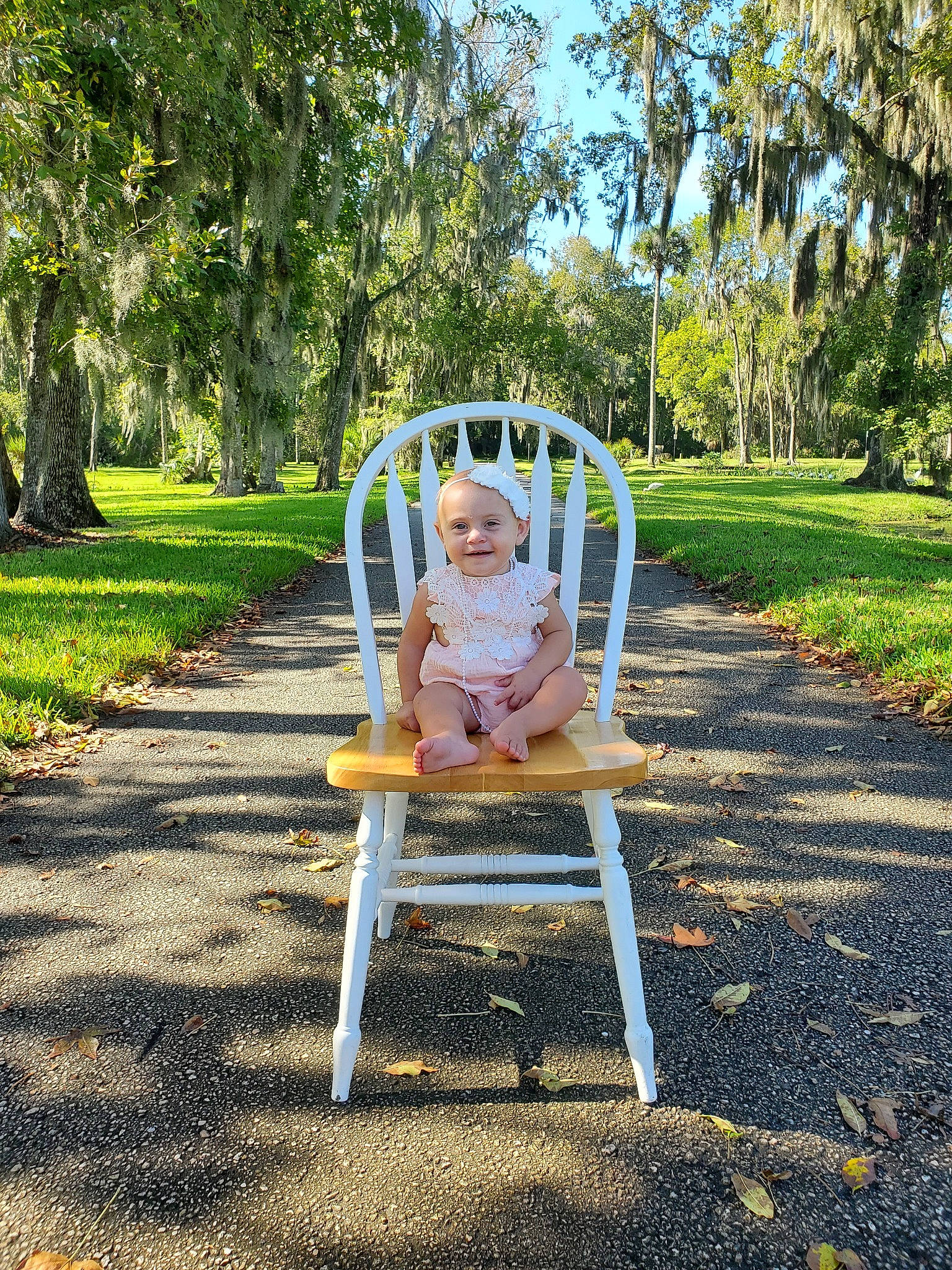 Stella is registered to the contest to win money with this photo: botany, chair, child, fun, furniture, garden, grass, joy, leisure, outdoor_furniture, outdoor_play_equipment, person, photograph, plant, product, public_space, sitting, summer, swing, toddler