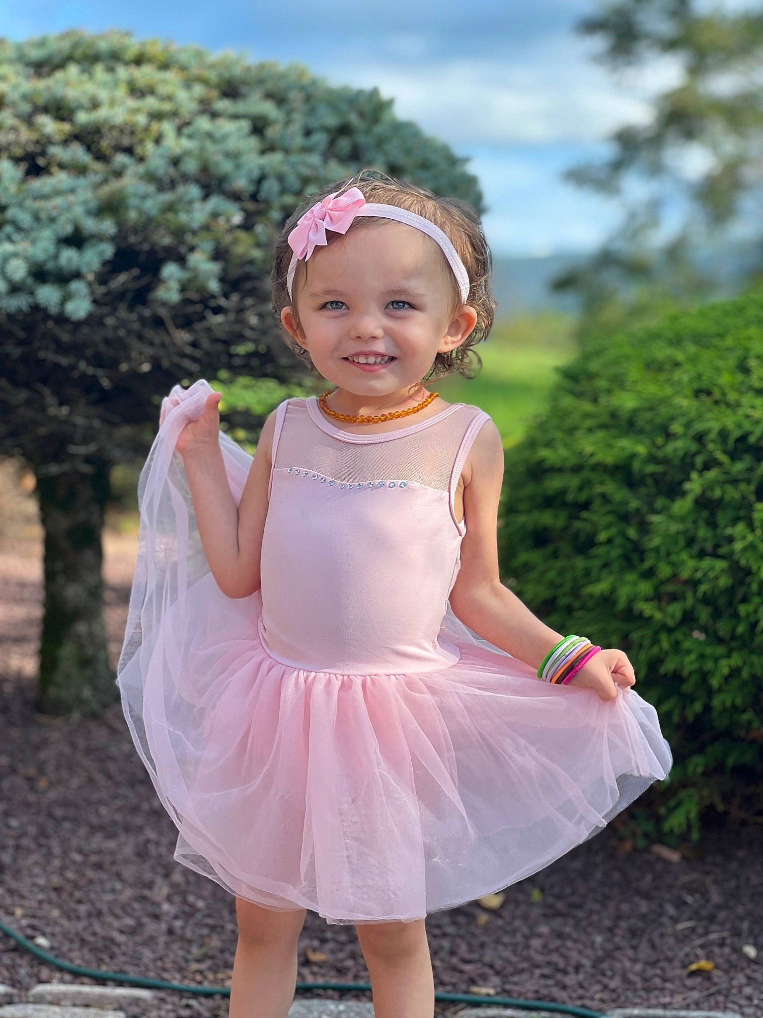 Evangelina is registered to the contest to win money with this photo: baby, baby_toddler_clothing, clothing, day_dress, dress, eye, face, flash_photography, fun, grass, happy, head, headwear, joy, magenta, people_in_nature, person, pink, skin, sky