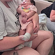 N'Veyah is registered to the contest to win money with this photo: baby, woman, holding, couch, tattoo, plant, indoor, smile, sleeping, onesie, person, comfort, love, family, casual, relaxation, home, skin, leg, happy