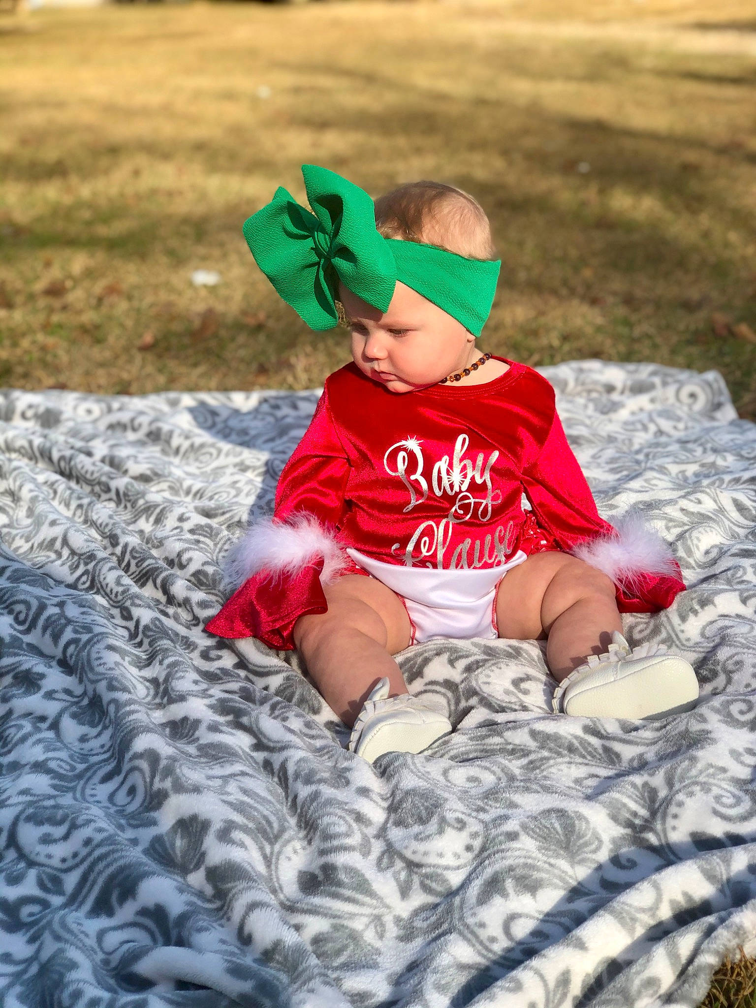 Adaleigh joined the competition — help win amazing prizes! baby, child, cool, fictional_character, grass, headgear, leaf, leisure, person, plant, play, red, sitting, toddler, vacation