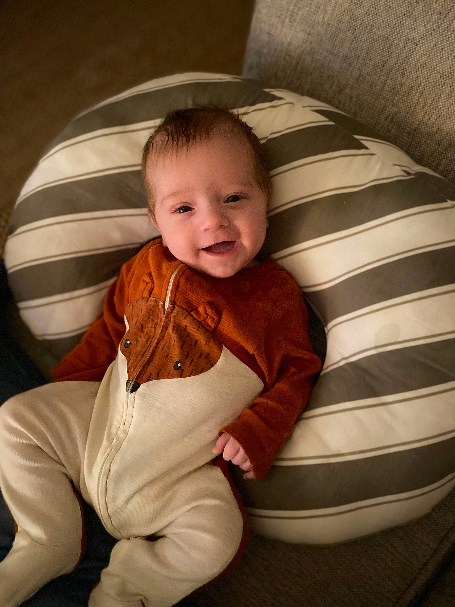 Julian is registered to the contest to win money with this photo: baby, baby_toddler_clothing, cheek, comfort, couch, eye, face, finger, flash_photography, floor, hairstyle, head, human_body, leg, mouth, person, skin, sleeve, smile, toddler