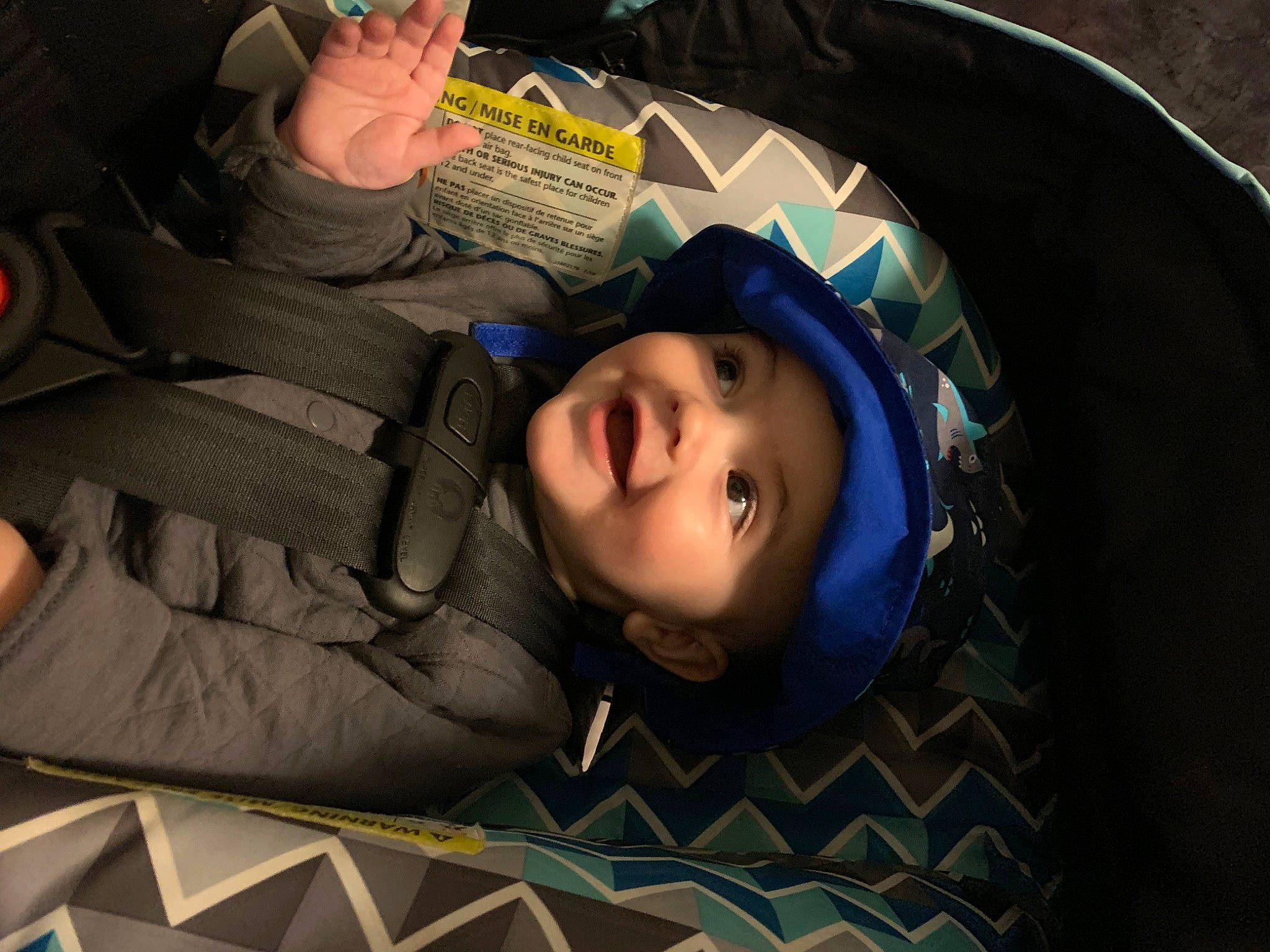 Kyrie is registered to the contest to win money with this photo: auto_part, automotive_tire, automotive_wheel_system, baby_products, car_seat, cheek, child, electric_blue, eyebrow, fashion_accessory, flash_photography, flooring, fun, headwear, mouth, pattern, person, personal_protective_equipment, sitting, smile