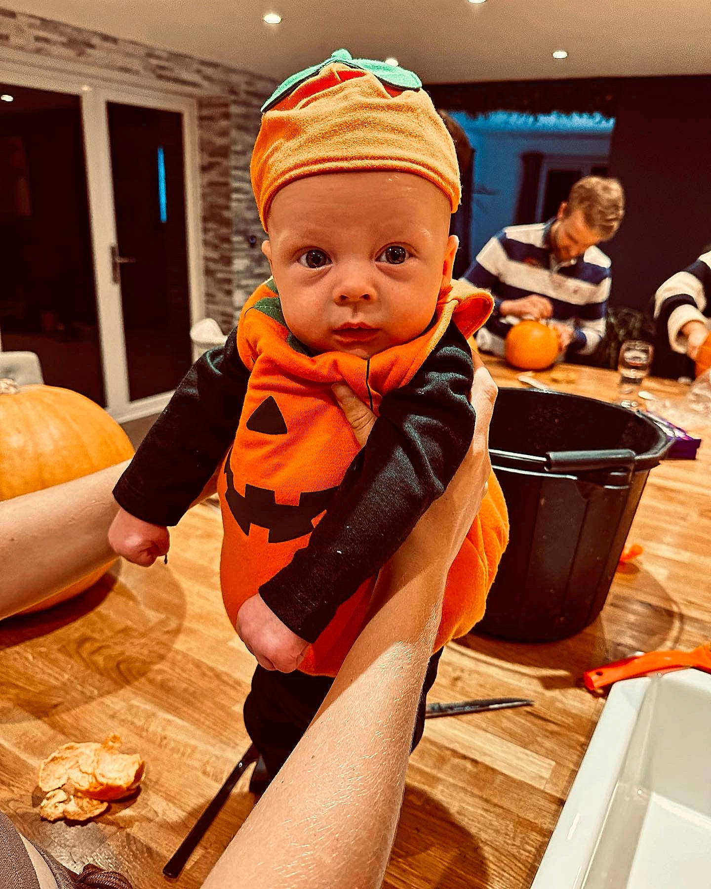 Fred is registered to the contest to win money with this photo: baby, baby_toddler_clothing, bag, calabaza, child, comfort, flooring, fun, gourd, headwear, orange, person, personal_protective_equipment, pumpkin, room, sitting, sleeve, toddler, winter_squash