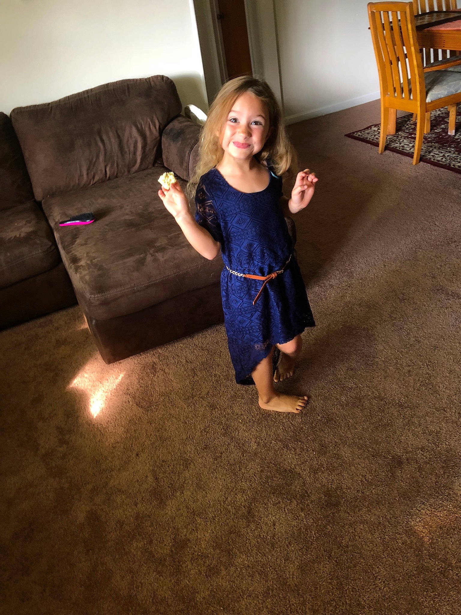 Fiona is registered to the contest to win money with this photo: carpet, child, couch, dress, electric_blue, floor, flooring, fun, furniture, hardwood, joint, leg, person, photograph, photography, shoe, shoulder, sitting, standing, toddler