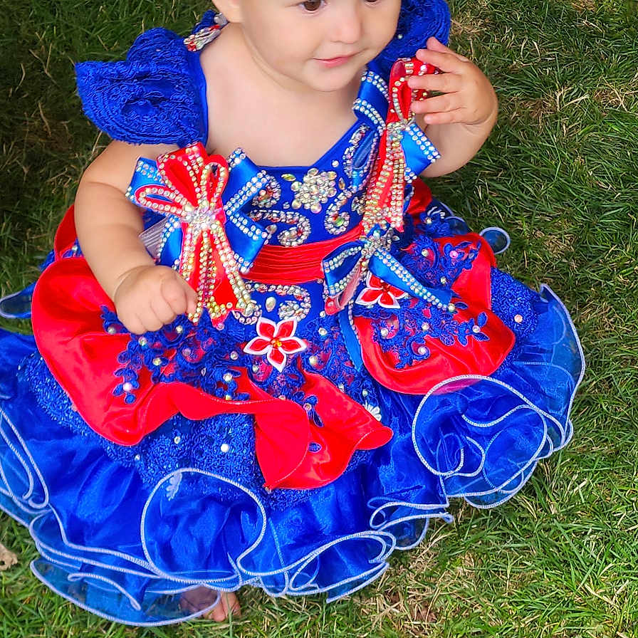 Amelia is registered to the contest to win money with this photo: baby, backyard, clothing, costume, dress, face, fashion, formalwear, gown, grass, hat, head, lawn, nature, outdoors, person, photography, plant, portrait, yard