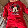 Maël a rejoint le concours — aidez-le/la à gagner de superbes lots ! baby, child, smiling, red_clothing, mickey_mouse, blanket, indoor, cute, portrait, happy, toddler, sitting, face, person, cozy, soft, apparel, infant, cute_expression, casual