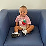 Lyna participe au concours pour gagner de l'argent avec cette photo : toddler, child, blue_eyes, pink_shirt, strawberry_design, white_shorts, white_sneakers, sitting, blue_armchair, leather_chair, playful_expression, tongue_out, indoor, casual_clothing, gold_chain, short_hair, cute, portrait, happy, person