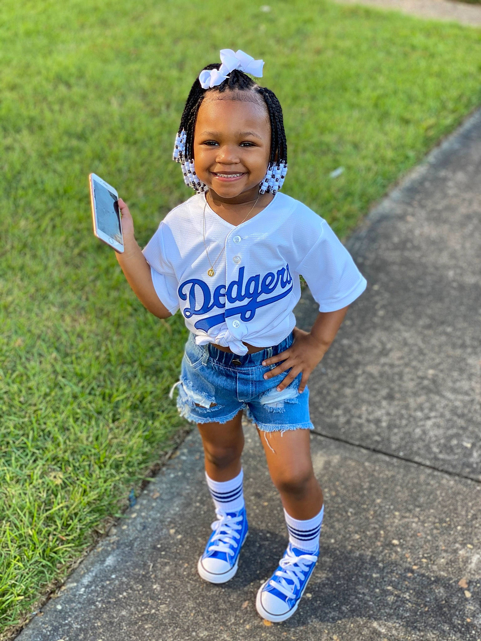 Nylah is registered to the contest to win money with this photo: asphalt, child, electric_blue, fun, grass, happy, human_leg, joy, knee, leisure, person, recreation, shoe, shorts, sleeve, smile, sneakers, summer, sunglasses, t_shirt