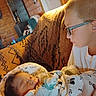 Leo joined the competition — help win amazing prizes! child, newborn, baby, sleeping, glasses, sibling, portrait, indoor, cozy, couch, blanket, patterned_fabric, wood_paneling, lamp, warm_lighting, family, infant, sitting, lying_down, home