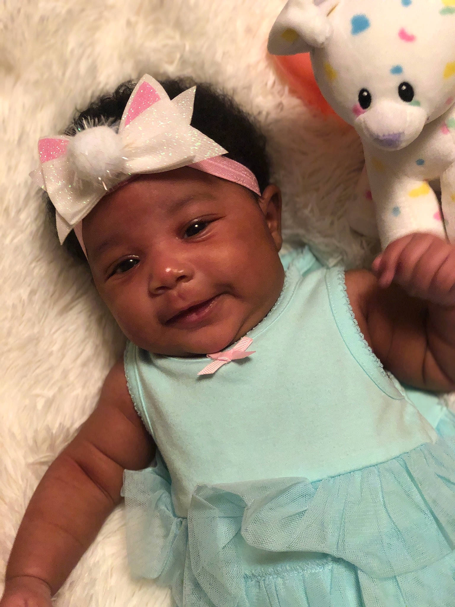 Zanyla is registered to the contest to win money with this photo: baby, child, ear, head, headwear, person, pink, skin, smile, stuffed_toy, teddy_bear, toddler, toy