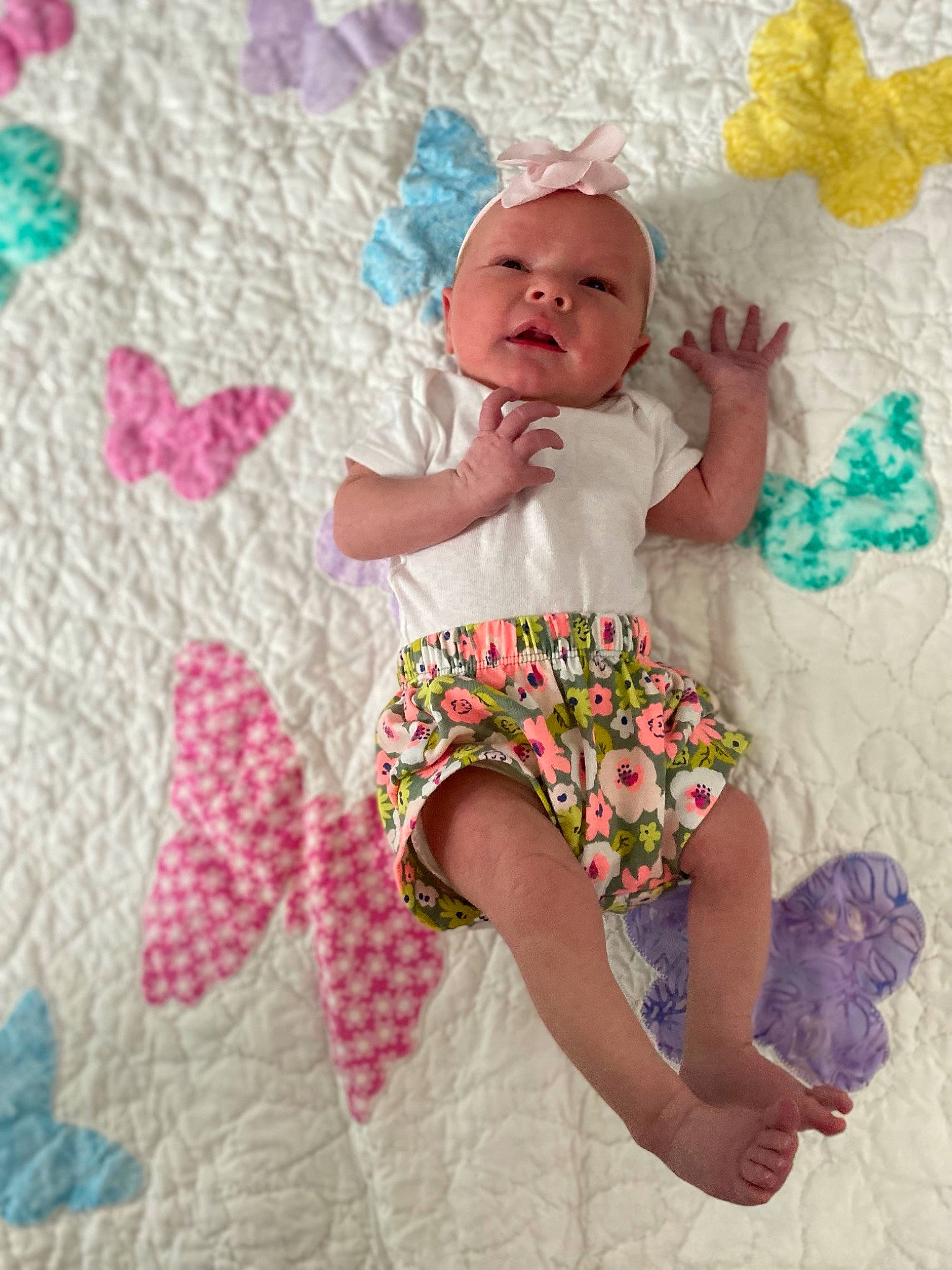 Oaklynn is registered to the contest to win money with this photo: baby, baby_toddler_clothing, barefoot, child, comfort, finger, hand, happy, headwear, linens, magenta, pattern, person, pink, product, purple, skin, sleeve, t_shirt, textile