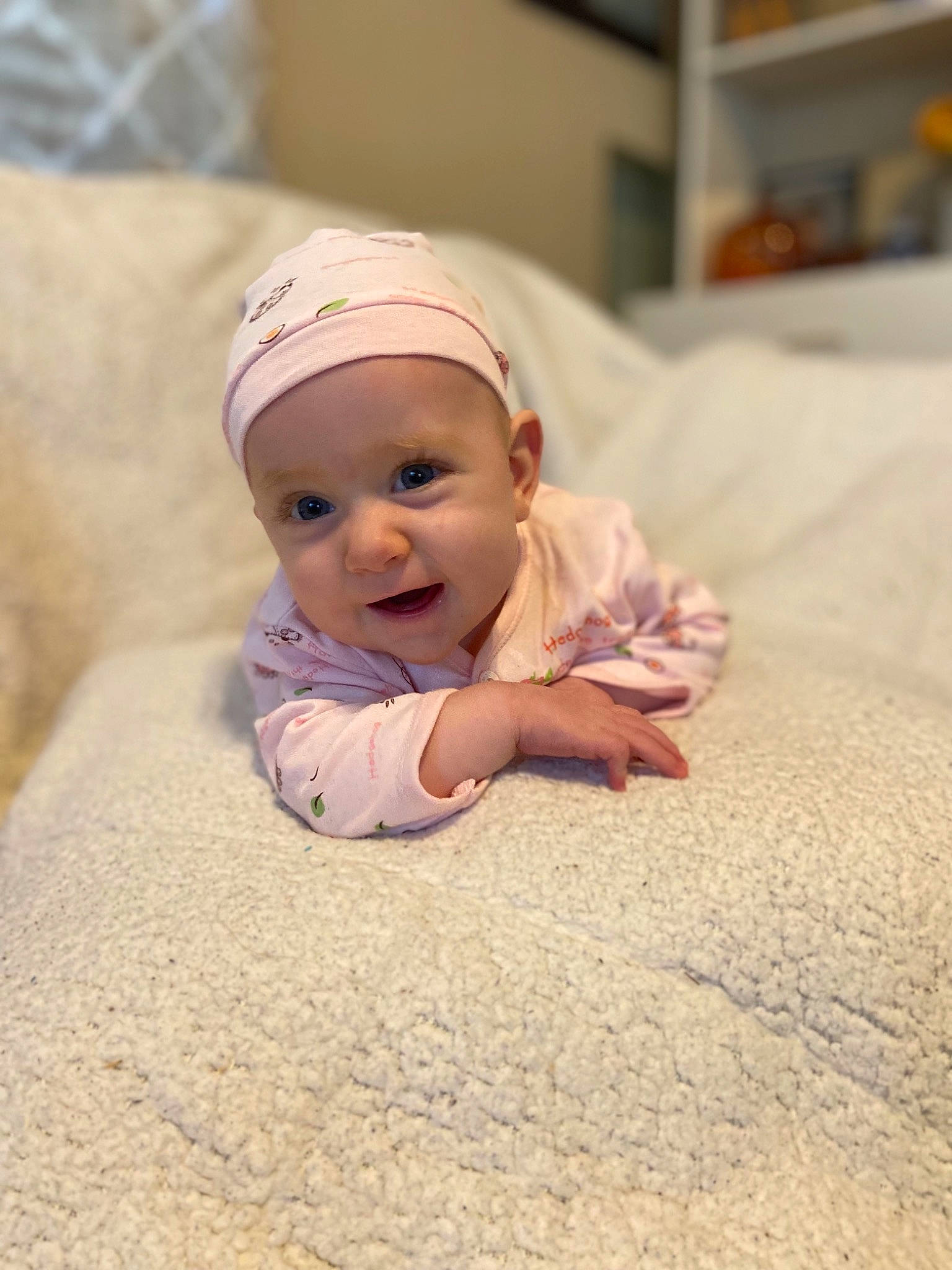 Avyanna is registered to the contest to win money with this photo: baby, baby_toddler_clothing, cap, child, chin, comfort, facial_expression, floor, flooring, fun, grass, happy, headwear, laugh, person, portrait_photography, room, sand, sitting, skin