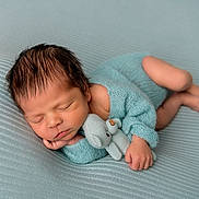 Domenic is registered to the contest to win money with this photo: newborn, baby, sleeping, blue_outfit, knitted_clothing, stuffed_elephant, cuddling, soft_texture, blanket, infant, peaceful, cute, portrait, child, resting, indoors, closeup, adorable, tiny_hand, laying_down