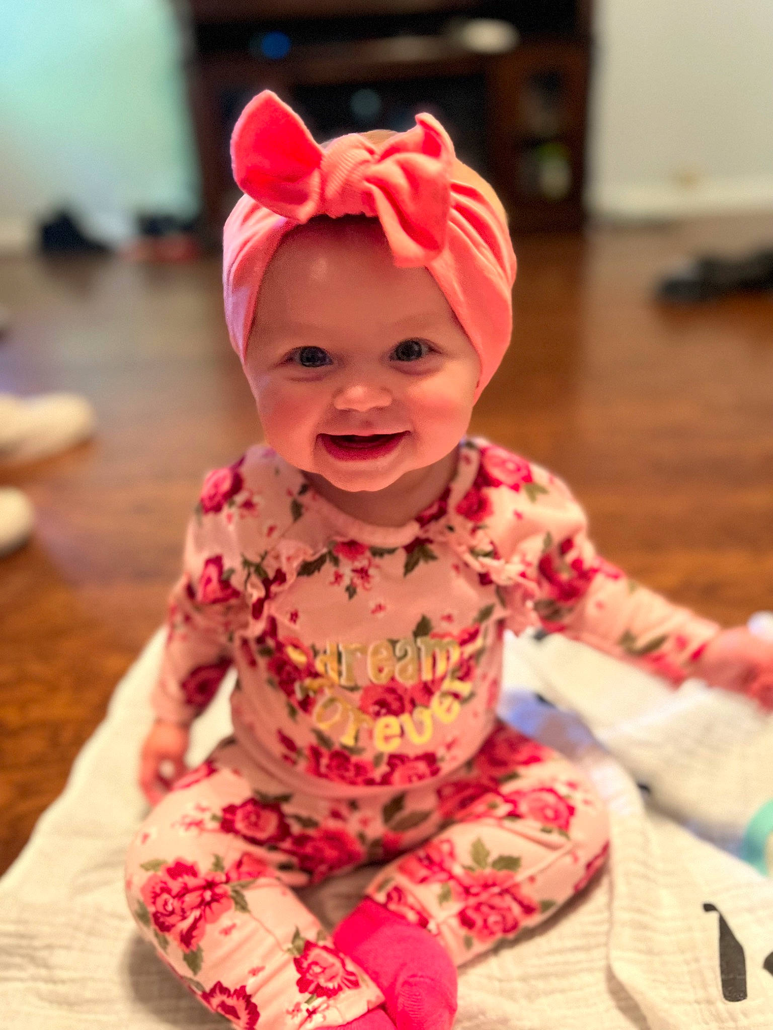 Paisley joined the competition — help win amazing prizes! baby, baby_laughing, baby_toddler_clothing, cheek, child, face, fashion_accessory, flooring, fun, happy, head, headgear, headwear, helmet, magenta, party_supply, person, pink, skin, sleeve