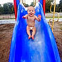Jordan joined the competition — help win amazing prizes! baby, child, slide, playground, diaper, outdoor, happy, smiling, blue_slide, play_equipment, trees, grass, daylight, fun, park, infant, climbing_frame, bare_chest, recreation, joy