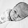 baby, infant, black_and_white, portrait, face, eyes, clothing, sleeping, soft, texture, laying_down, peaceful, head, cute, newborn, closeup, expression, skin, monochrome, resting