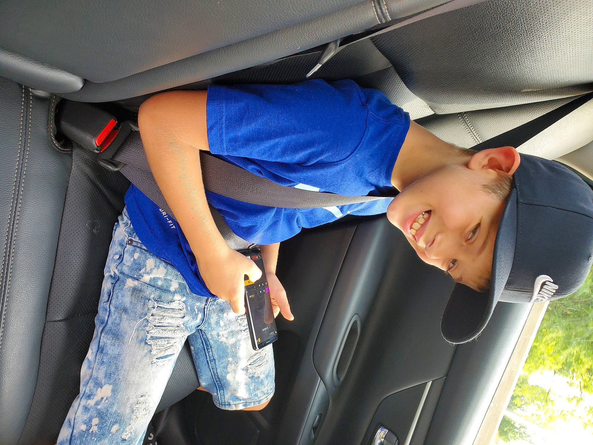 Erich is registered to the contest to win money with this photo: automotive_window_part, car_seat, comfort, denim, elbow, electric_blue, headwear, hip, joy, person, pocket, service, vehicle_door, walking_shoe