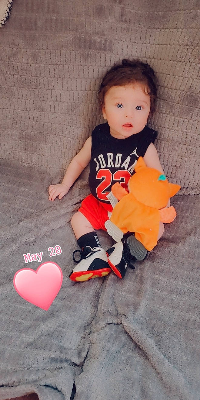 Karsyn is registered to the contest to win money with this photo: arm, baby, baby_toddler_clothing, child, dress, finger, flooring, hair, happy, head, human_body, leg, orange, person, pink, shorts, sleeve, surprise, t_shirt, textile