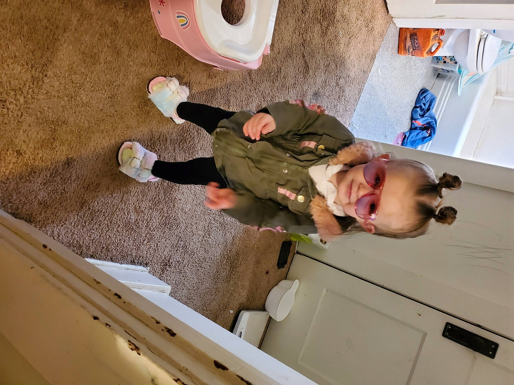 Jessi is registered to the contest to win money with this photo: baby, baby_toddler_clothing, building, ceiling, child, comfort, floor, flooring, fun, hardwood, laundry_room, person, plaster, room, smile, t_shirt, toddler, wall, wood, wood_flooring