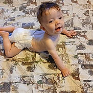 Skylar joined the competition — help win amazing prizes! baby, diaper, smile, lying_down, quilt, animal_print, child, happy, cute, infant, skin, hand, foot, bedspread, pattern, portrait, indoors, young_child, head, face
