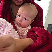 Eren joined the competition — help win amazing prizes! baby, man, robe, blanket, indoor, person, infant, curious, face, expression, holding, closeup, skin, bedroom, candid, comfort, warmth, portrait, family, love