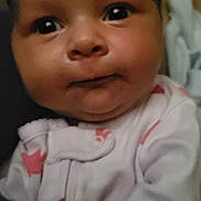 Kaisley joined the competition — help win amazing prizes! baby, infant, child, portrait, close_up, face, eyes, wide_eyed, smiling, indoor, onesie, clothing, pink, patterned, bedding, soft_lighting, head, cheeks, looking_at_camera, photography