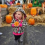 child, pumpkin, autumn, fall, hay_bale, leopard_print, hoodie, boots, outdoor, festival, smiling, cute, person, pumpkin_patch, orange, scarecrow, farm, harvest, holiday, seasonal