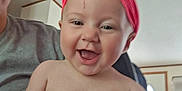 Journey joined the competition — help win amazing prizes! baby, smiling, headwrap, pink, child, adult_hand, indoor, person, happy, portrait, skin, face, holding, closeup, head, expression, cute, infant, family, casual