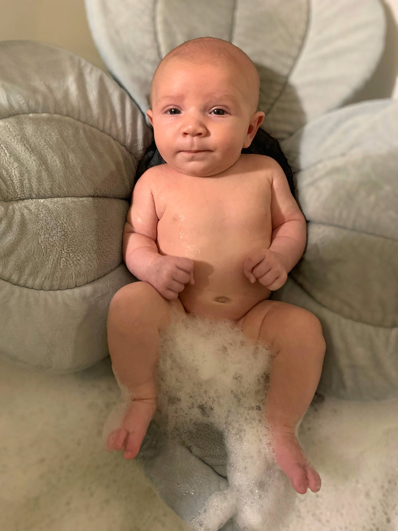 Oliver is registered to the contest to win money with this photo: abdomen, arm, baby, cheek, chest, comfort, couch, eye, face, finger, head, human_body, lip, no_expression, person, sitting, skin, stomach, thumb, toddler