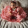 Ambre a rejoint le concours — aidez-le/la à gagner de superbes lots ! adorable, baby, blanket, child, clothing, curious_expression, cute, decorative_ruffles, fashion, footwear, hair_buns, indoor, light_and_shadow, pink_dress, portrait, puffy_sleeves, seated, soft_texture, toddler, young_child