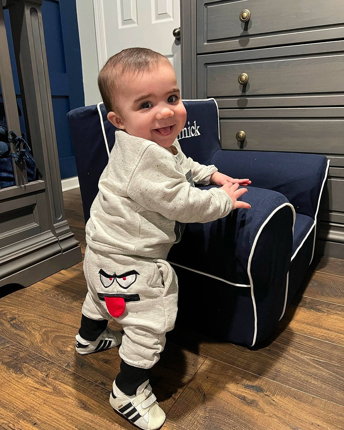 Dominick is registered to the contest to win money with this photo: baby, baby_toddler_clothing, cabinetry, child, comfort, door, floor, flooring, fun, happy, hardwood, home_door, person, play, room, shoe, sitting, sleeve, smile, toddler