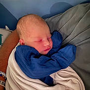 Lincoln is registered to the contest to win money with this photo: newborn, baby, sleeping, blanket, cushion, arm, resting, cozy, infant, child, soft, comfort, peaceful, indoors, portrait, wrapped, clothing, skin, head, face