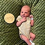 Lincoln is registered to the contest to win money with this photo: newborn, baby, infant, striped_onesie, hospital_bracelet, green_blanket, texture, lying_down, peaceful, portrait, human, person, skin, head, hands, feet, sleepwear, cuddly, cute, resting