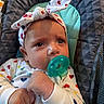 Summer is registered to the contest to win money with this photo: baby, infant, child, portrait, sitting, pacifier, headband, bow, hearts, pajamas, onesie, clothing, blue_eyes, face, hands, baby_seat, cushion, indoor, close_up, adorable