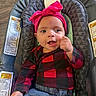 baby, infant, child, portrait, smiling, happy, bow_headband, pink, plaid_shirt, jeans, bouncer, baby_seat, sitting, indoors, wood_floor, face, eyes, fist, fashion, close_up