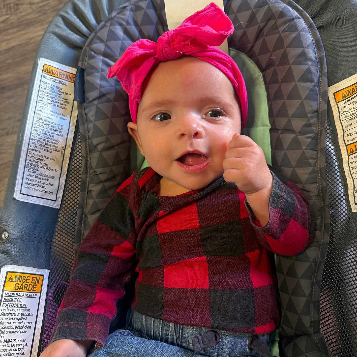 Summer joined the competition — help win amazing prizes! baby, infant, child, portrait, smiling, happy, bow_headband, pink, plaid_shirt, jeans, bouncer, baby_seat, sitting, indoors, wood_floor, face, eyes, fist, fashion, close_up